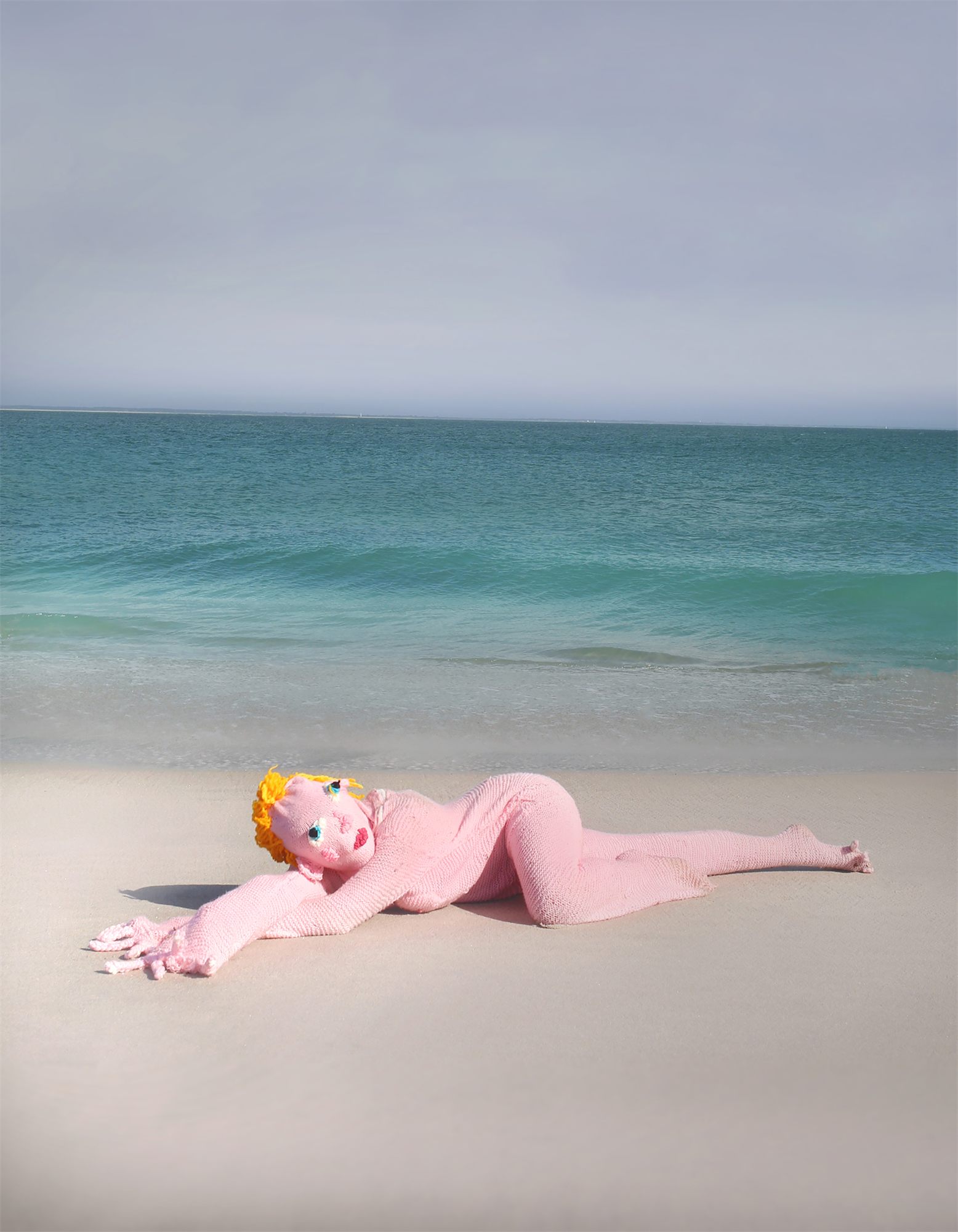 Éva Ostrowska, Love was Sweet and Warm as a Tangerine Sunrise, two pink knitted figures crouching on grey rocks, photographic performance